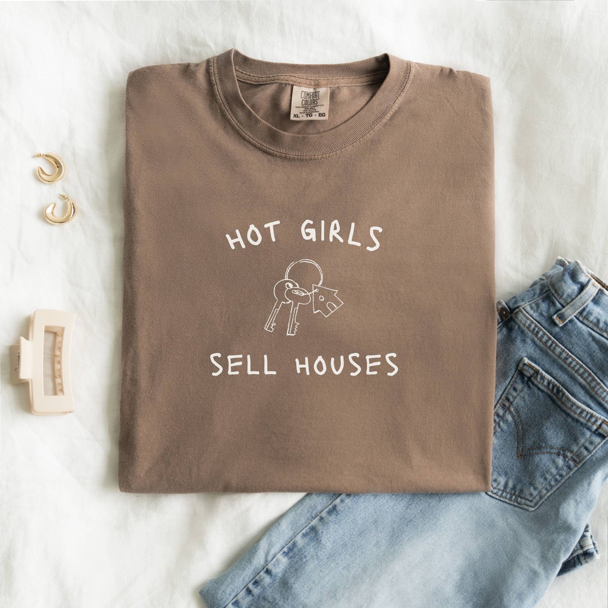T-shirt with 'Hot Girls Sell Houses' text and hand-drawn house keys illustration in black