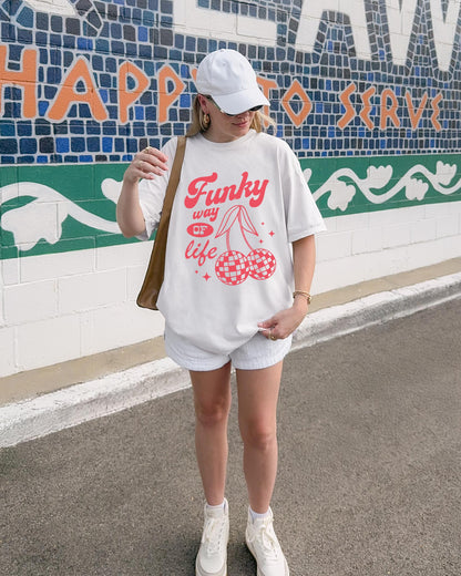 T-shirt with red retro cherry design featuring checkered disco ball cherries and funky typography