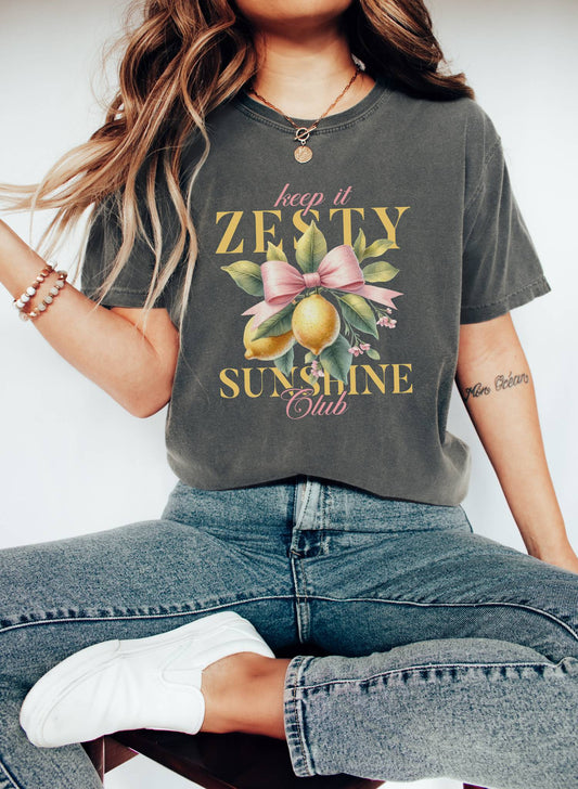 T-shirt with Keep It Zesty Sunshine Club text featuring watercolor lemons with pink bow and green leaves