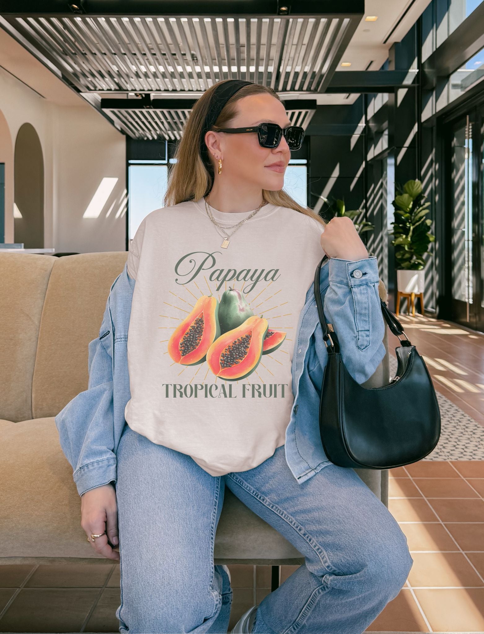 T-shirt featuring watercolor papaya fruits with golden sunburst rays and elegant Papaya script text