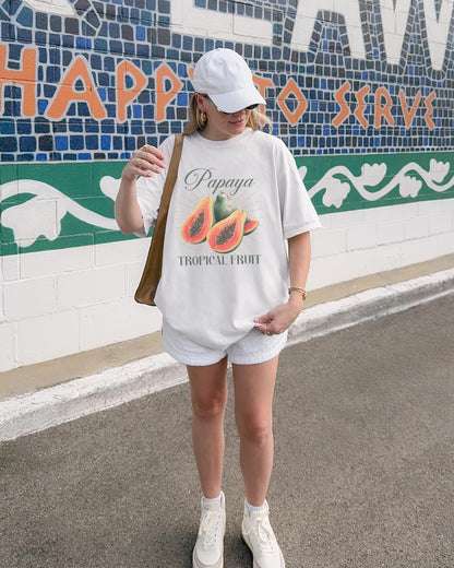 T-shirt featuring watercolor papaya fruits with golden sunburst rays and elegant Papaya script text