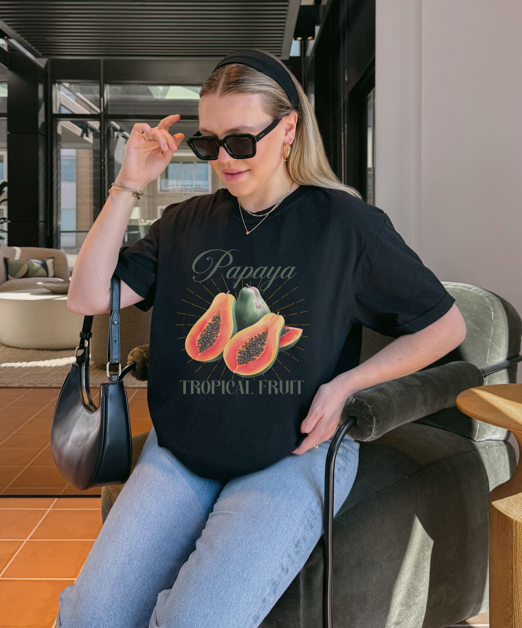 T-shirt featuring watercolor papaya fruits with golden sunburst rays and elegant Papaya script text