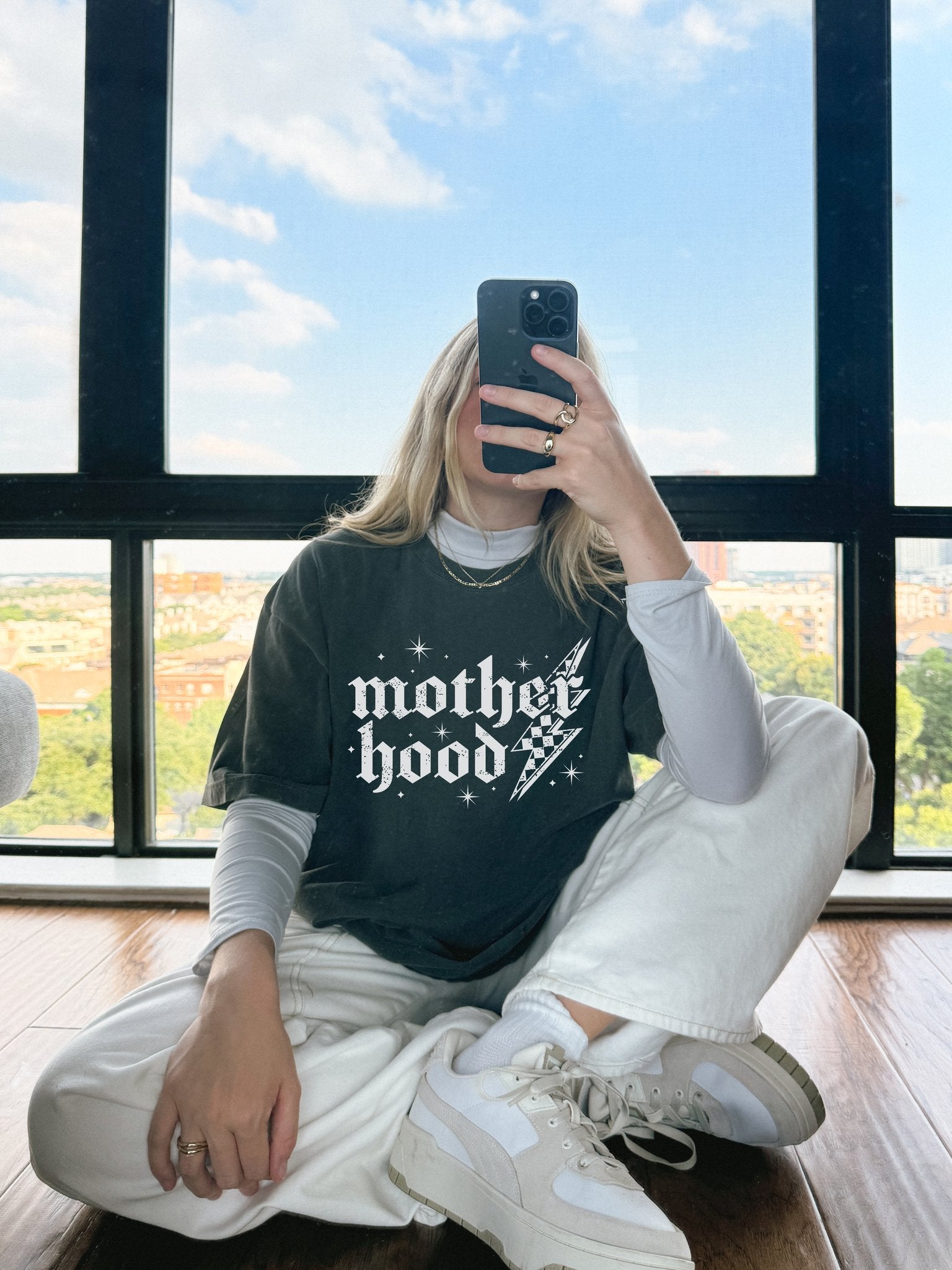 T-shirt with gothic Mother Hood text, lightning bolt graphics, and checkerboard pattern elements