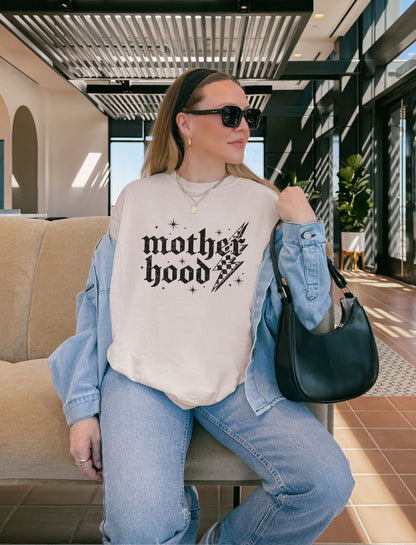 T-shirt with gothic Mother Hood text, lightning bolt graphics, and checkerboard pattern elements