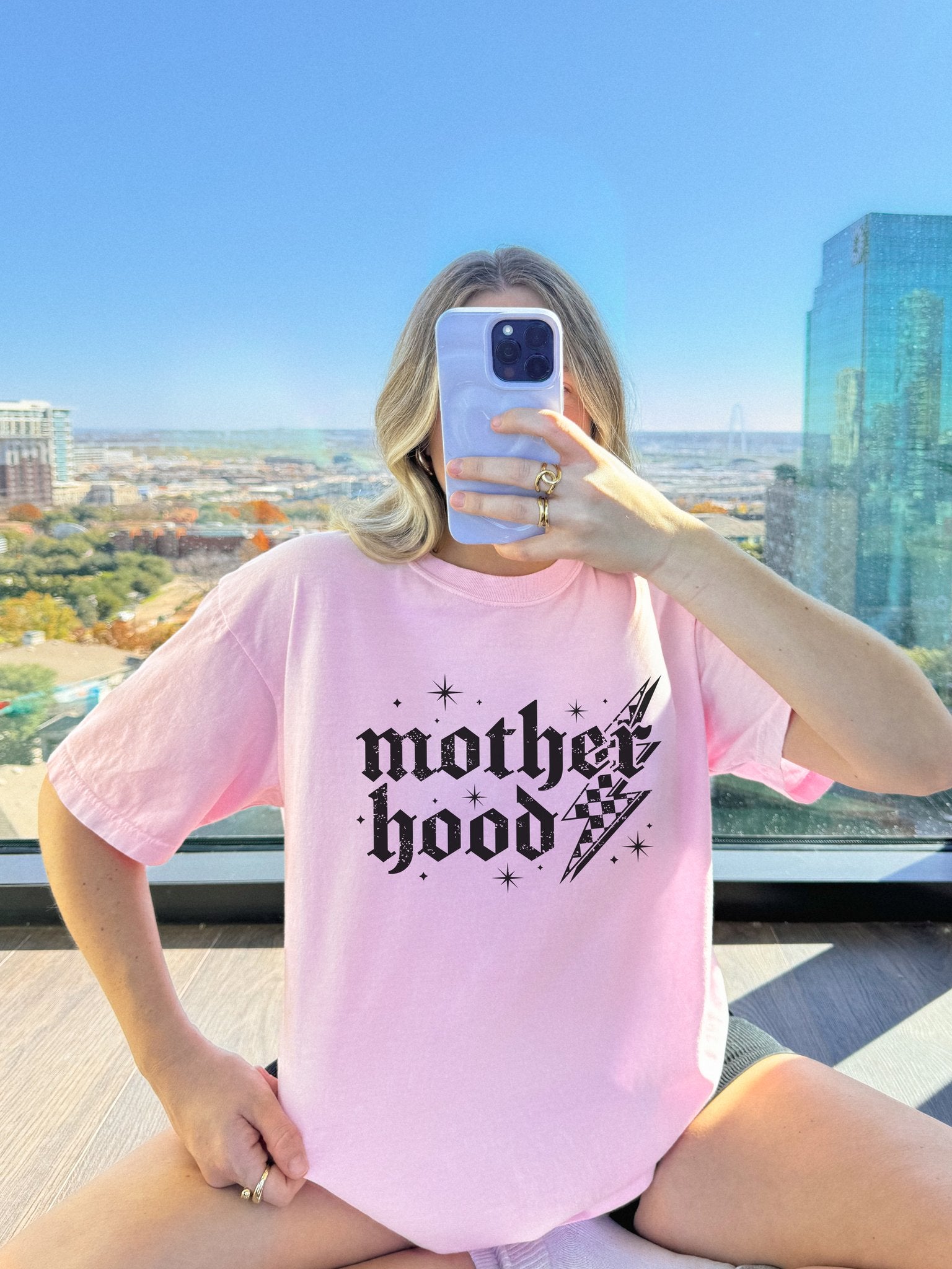 T-shirt with gothic Mother Hood text, lightning bolt graphics, and checkerboard pattern elements