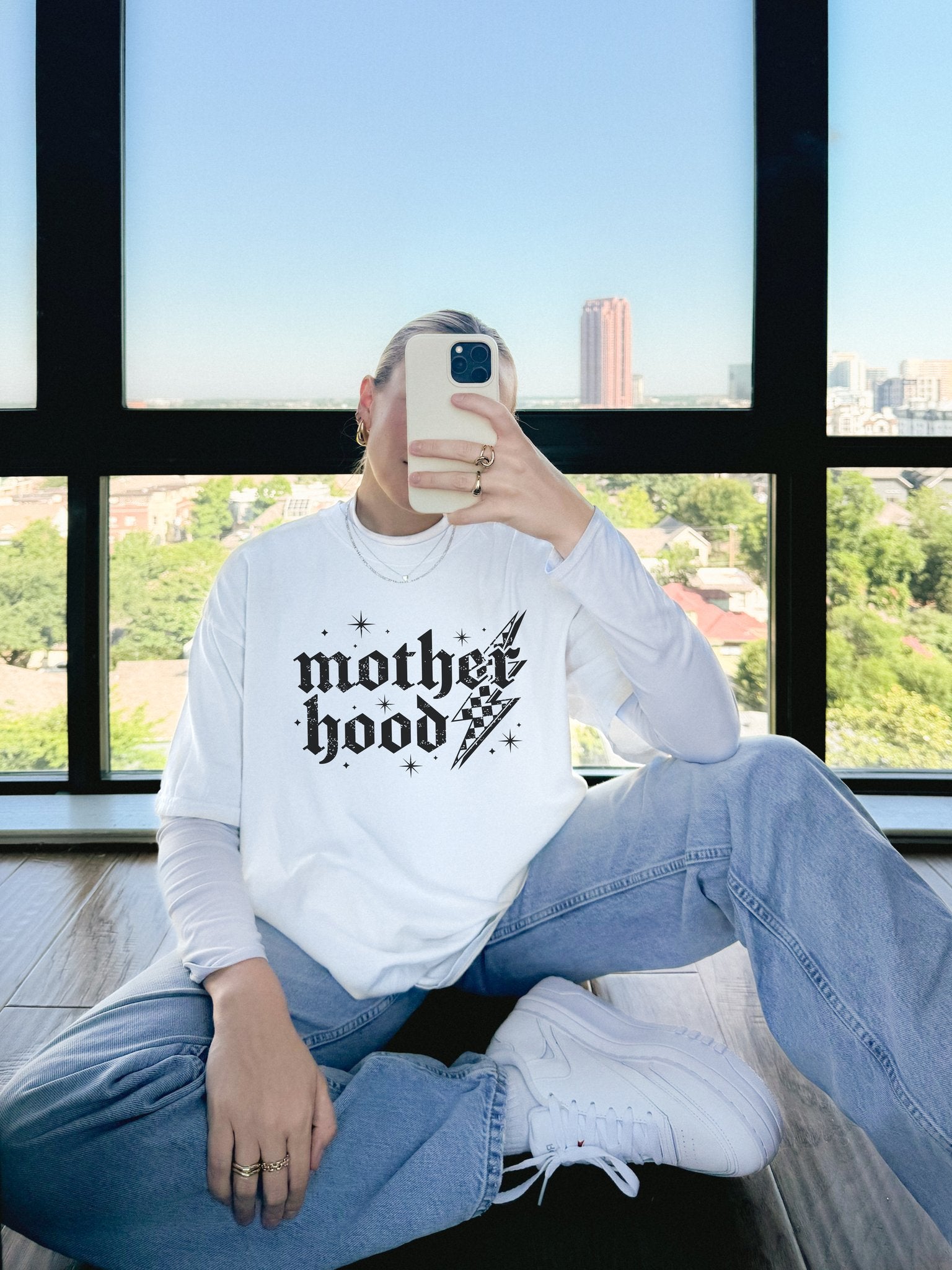 T-shirt with gothic Mother Hood text, lightning bolt graphics, and checkerboard pattern elements