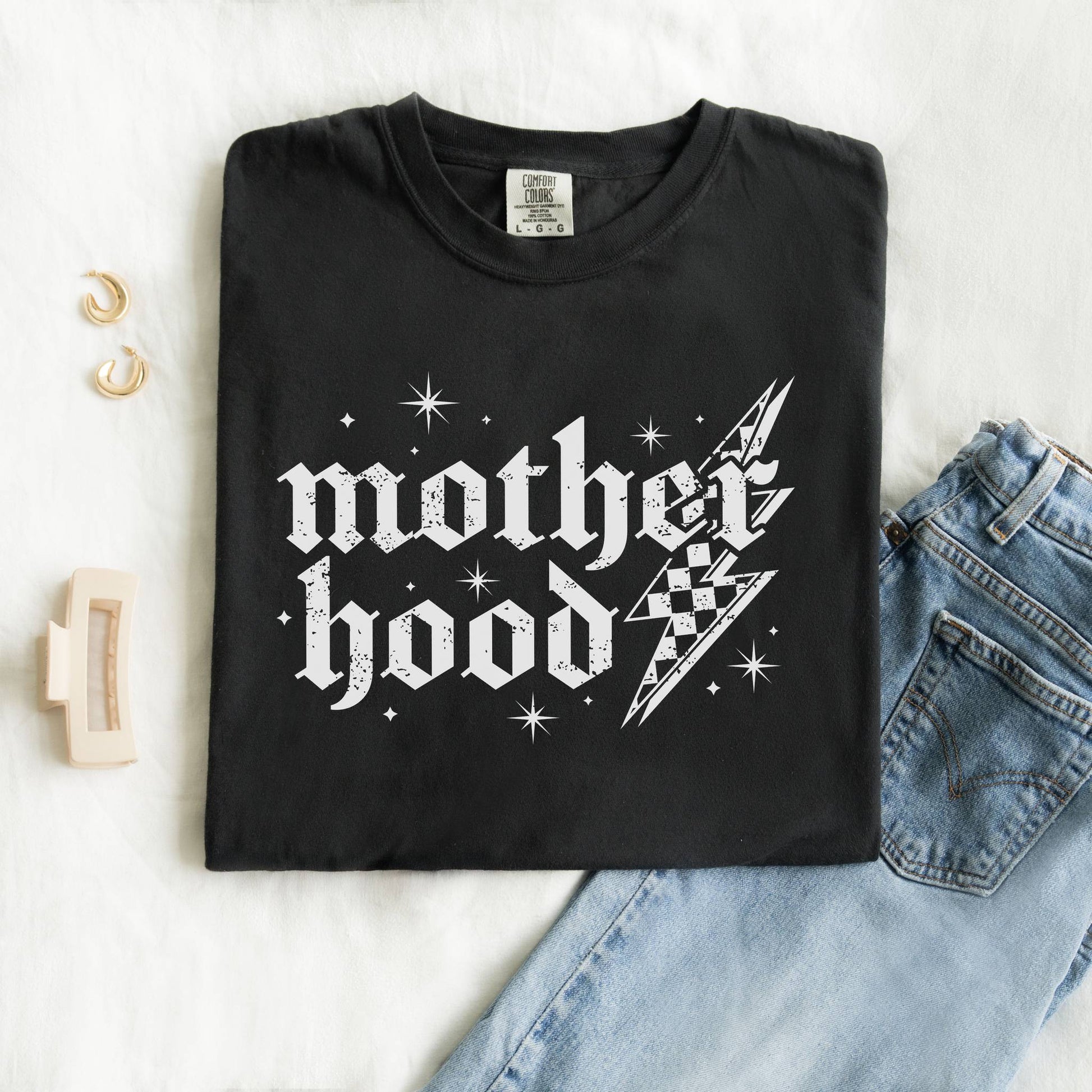 T-shirt with gothic Mother Hood text, lightning bolt graphics, and checkerboard pattern elements