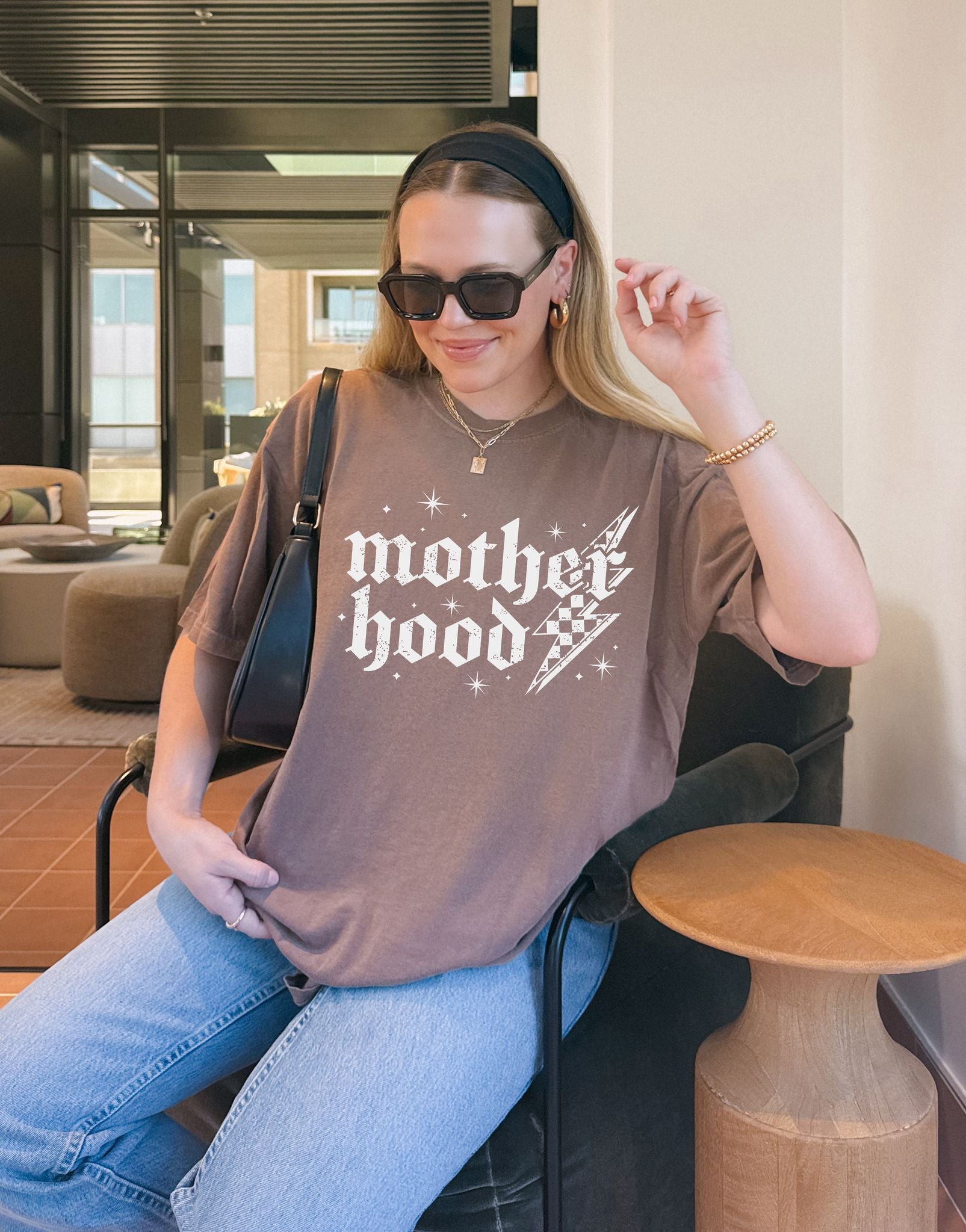 T-shirt with gothic Mother Hood text, lightning bolt graphics, and checkerboard pattern elements