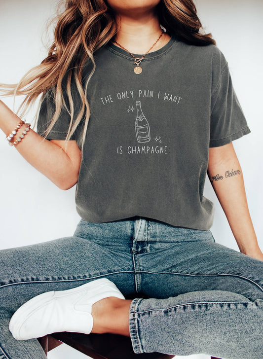 T-shirt with champagne bottle illustration and text 'The Only Pain I Want Is Champagne'