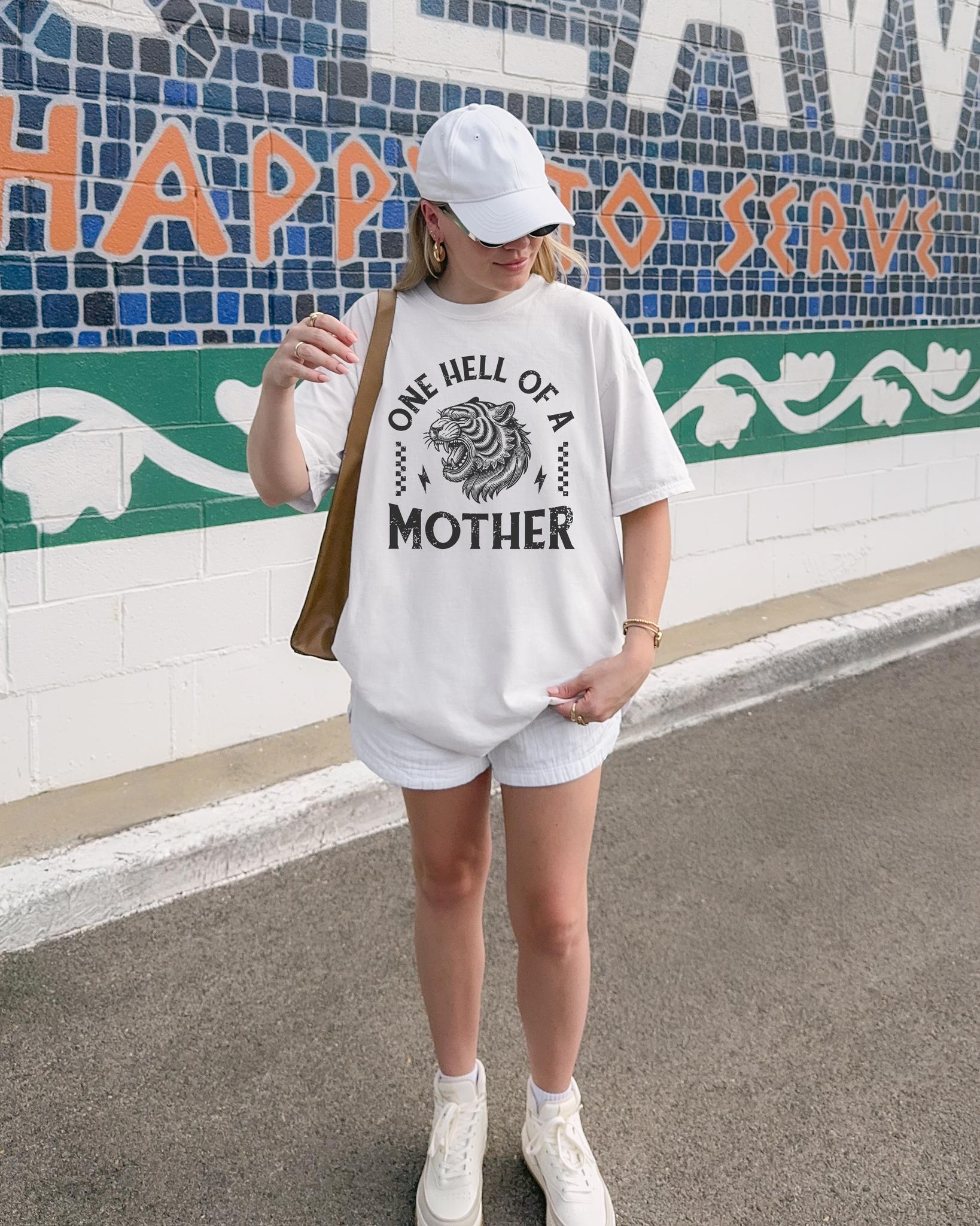 Black and white t-shirt with roaring tiger head and 'One Hell Of A Mother' text in distressed lettering