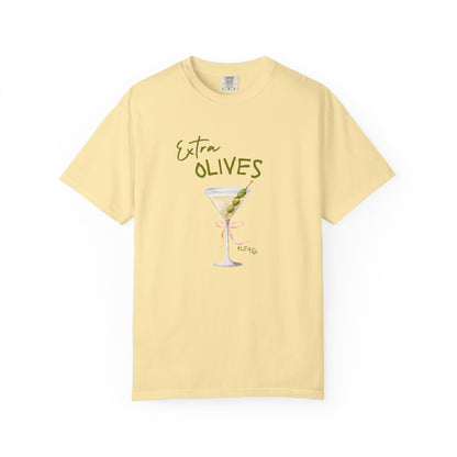 T-shirt design with martini glass, green olives, and pink bow saying Extra Olives Please