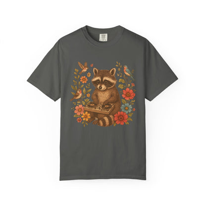 T-shirt with vintage raccoon DJ design surrounded by coral flowers, yellow blooms, and songbirds