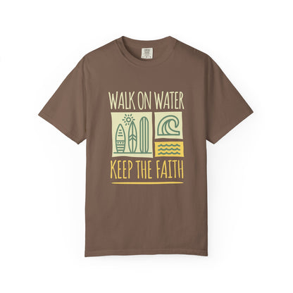 T-shirt with yellow Walk On Water Keep The Faith text, retro surfboard graphics and teal wave designs