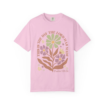 T-shirt with 'This is the Day' text, Psalm 118:24 verse, and floral design with protective hands in sage green, pink, and terracotta colors