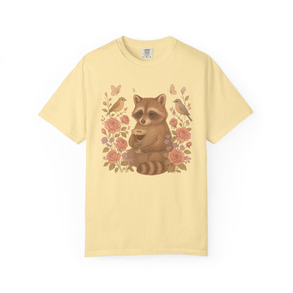 T-shirt with raccoon holding espresso martini glass surrounded by pink roses and birds