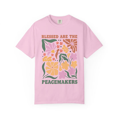 T-shirt with 'Blessed Are The Peacemakers' text surrounded by colorful floral design in pink, coral, yellow and green