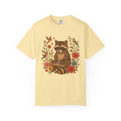T-shirt with vintage raccoon DJ design surrounded by coral flowers, yellow blooms, and songbirds