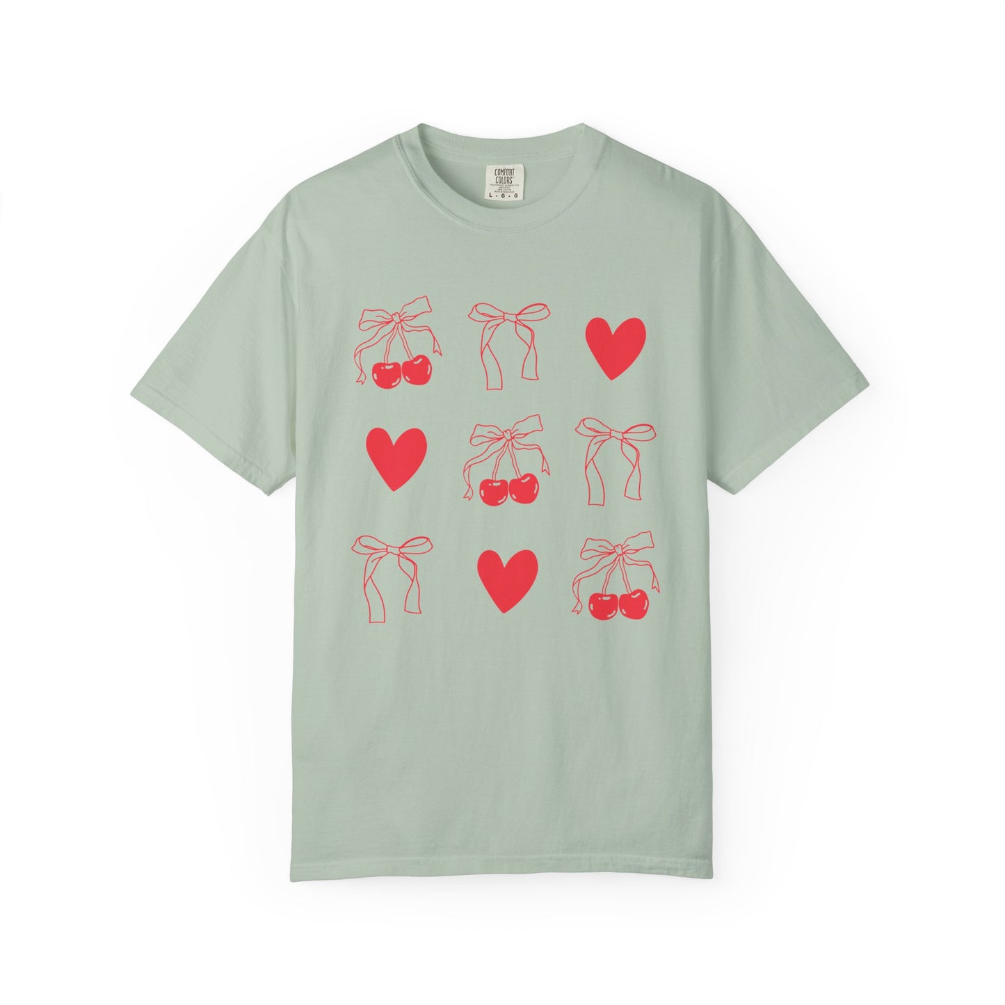 T-shirt with red cherry and bow pattern featuring hearts and ribbon bow designs