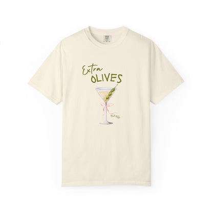 T-shirt design with martini glass, green olives, and pink bow saying Extra Olives Please
