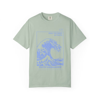 T-shirt with blue ocean wave design featuring 'Ride The Wave Of Faith' and 'Faith Unshaken' text