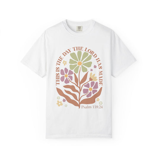 T-shirt with 'This is the Day' text, Psalm 118:24 verse, and floral design with protective hands in sage green, pink, and terracotta colors