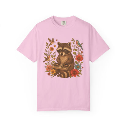 T-shirt with vintage raccoon DJ design surrounded by coral flowers, yellow blooms, and songbirds