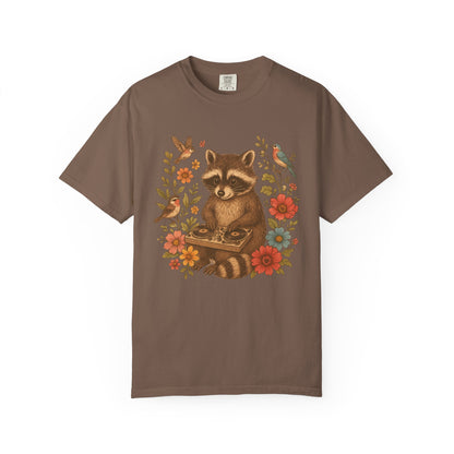 T-shirt with vintage raccoon DJ design surrounded by coral flowers, yellow blooms, and songbirds