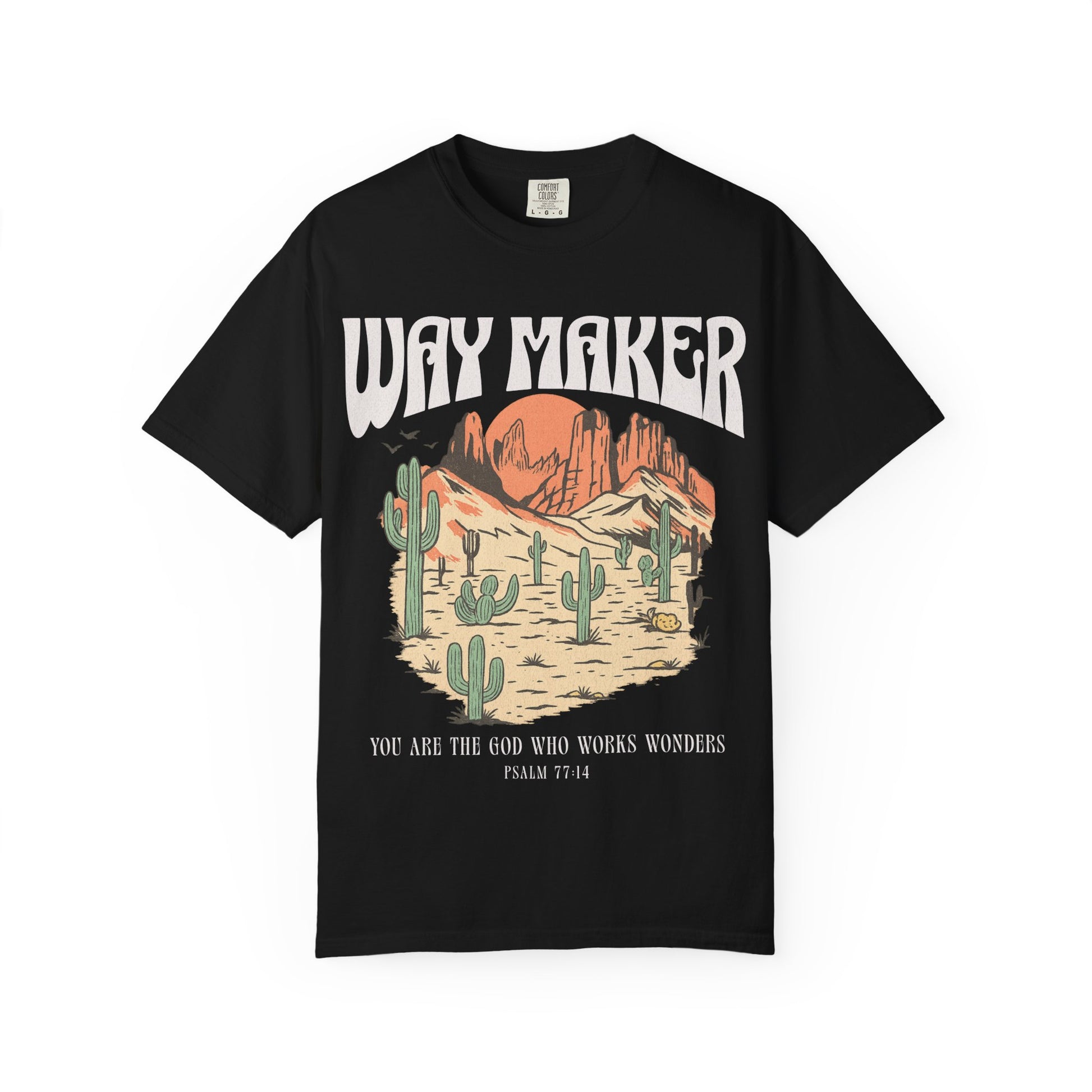 T-shirt with Way Maker text, desert landscape featuring cacti, mountains, and orange sunset with Psalm 77:14 verse
