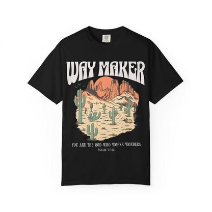 T-shirt with Way Maker text, desert landscape featuring cacti, mountains, and orange sunset with Psalm 77:14 verse