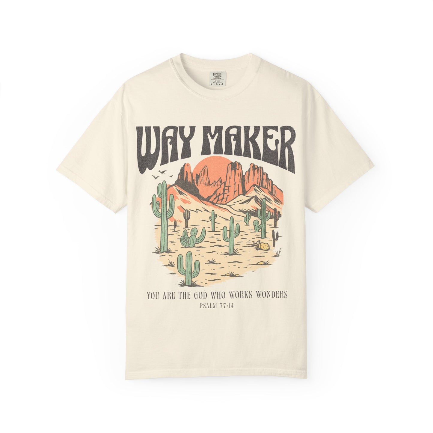 T-shirt with Way Maker text, desert landscape featuring cacti, mountains, and orange sunset with Psalm 77:14 verse