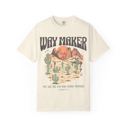 T-shirt with Way Maker text, desert landscape featuring cacti, mountains, and orange sunset with Psalm 77:14 verse