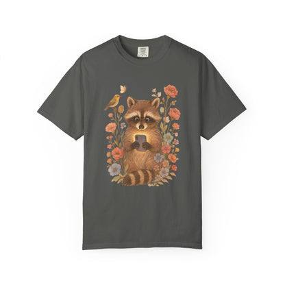 T-shirt with cute raccoon holding smartphone surrounded by coral and blue wildflowers