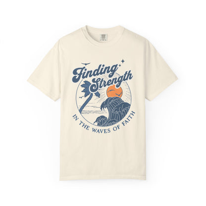 T-shirt with retro Christian design featuring palm tree, sunset, and ocean waves with Finding Strength text