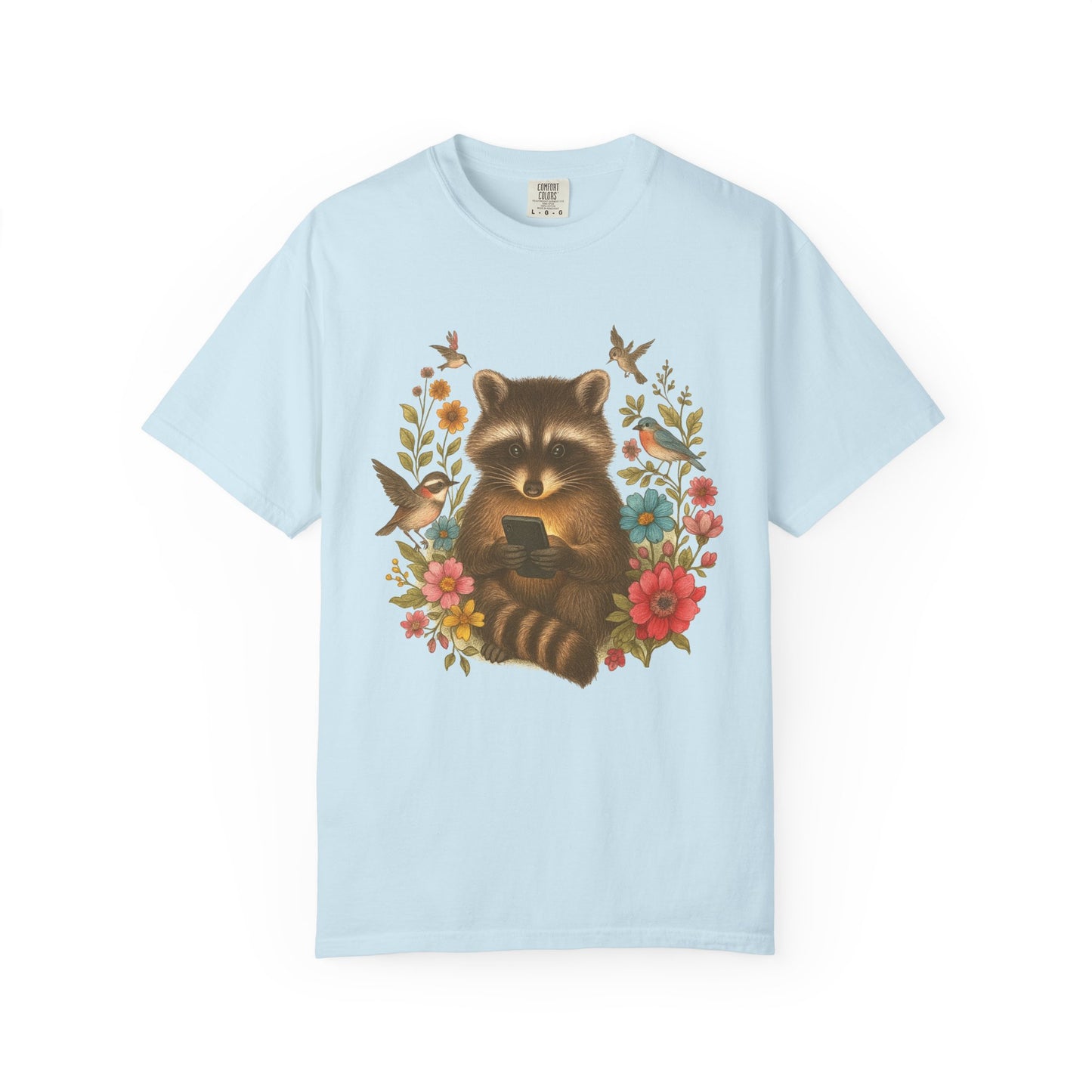 T-shirt design showing raccoon holding phone surrounded by colorful wildflowers and birds